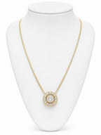 Gold necklace with a diamond pendant on a white mannequin bust