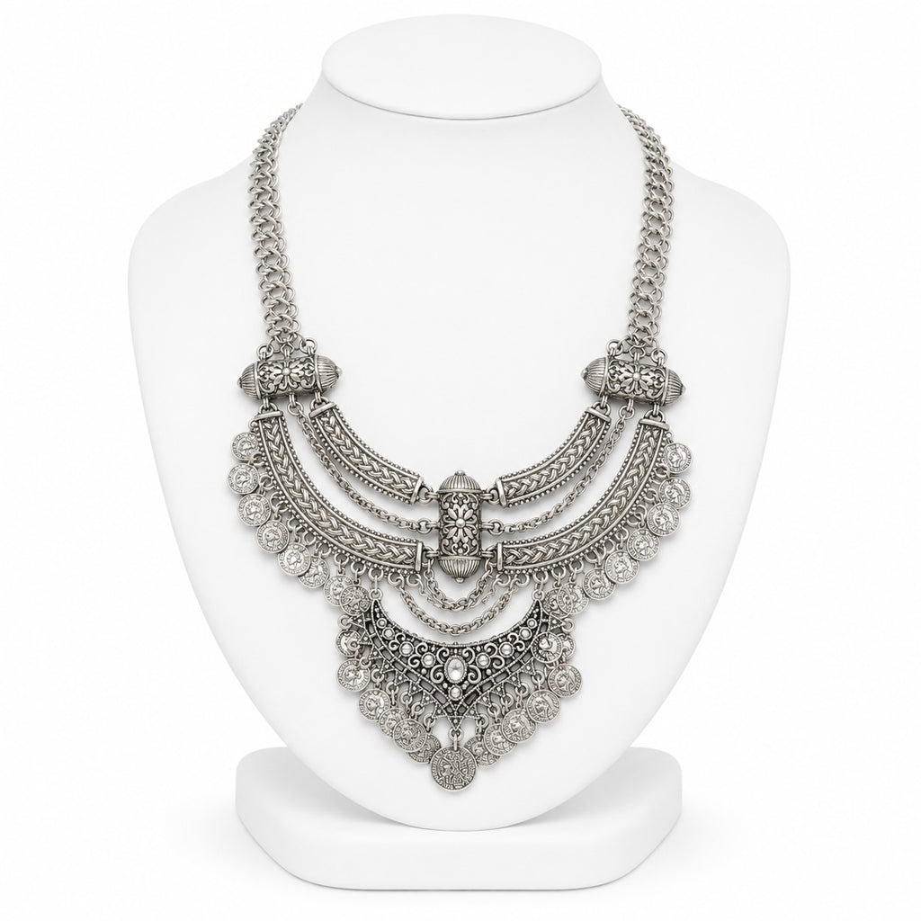 Silver necklace on a white mannequin bust against a white background