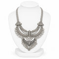 Silver necklace on a white mannequin bust against a white background