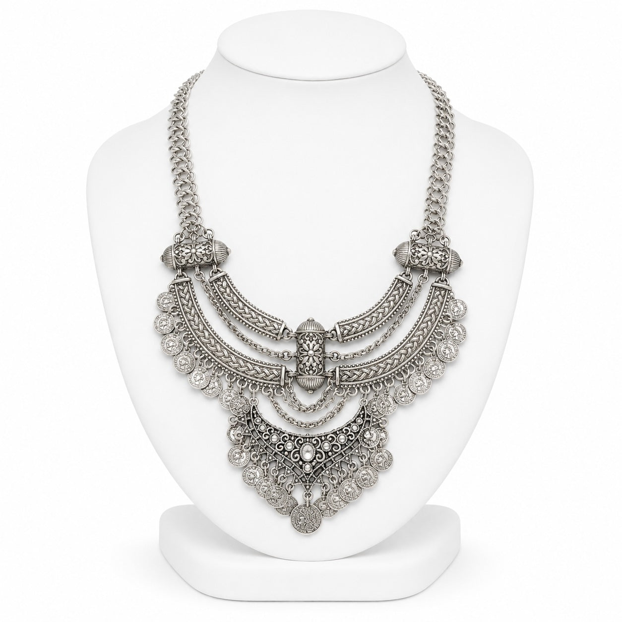 Silver necklace on a white mannequin bust against a white background