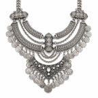 Ornate silver necklace on a white background