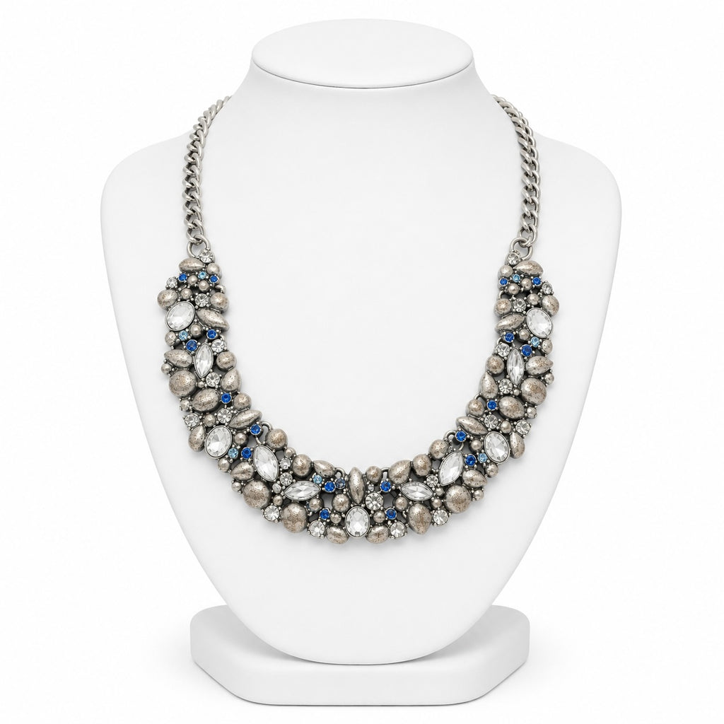 Necklace with pearls and blue stones on a white mannequin bust