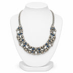 Necklace with pearls and blue stones on a white mannequin bust
