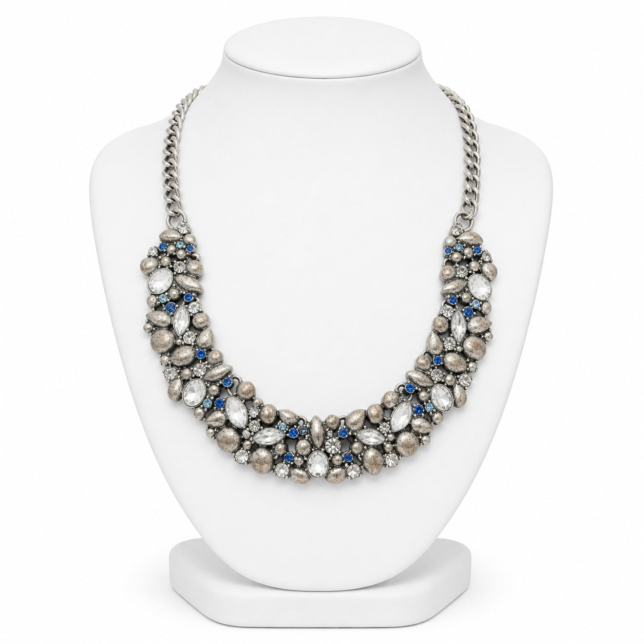 Necklace with pearls and blue stones on a white mannequin bust