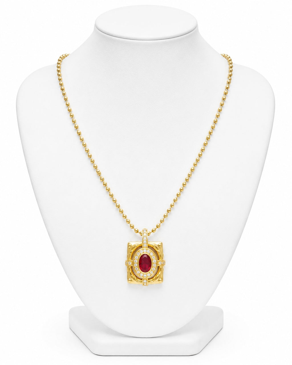 Gold necklace with a red gemstone pendant on a white mannequin bust.