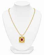 Gold necklace with a red gemstone pendant on a white mannequin bust.