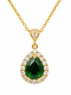 Gold necklace with a green teardrop pendant and diamond accents on a white background