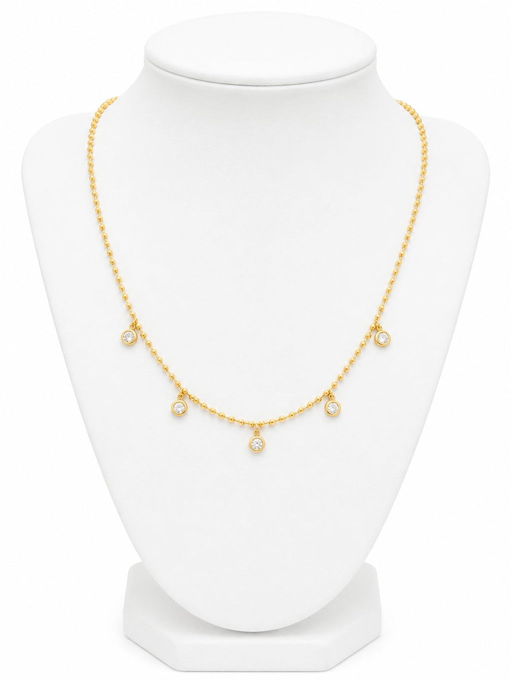 Gold necklace on a white mannequin bust