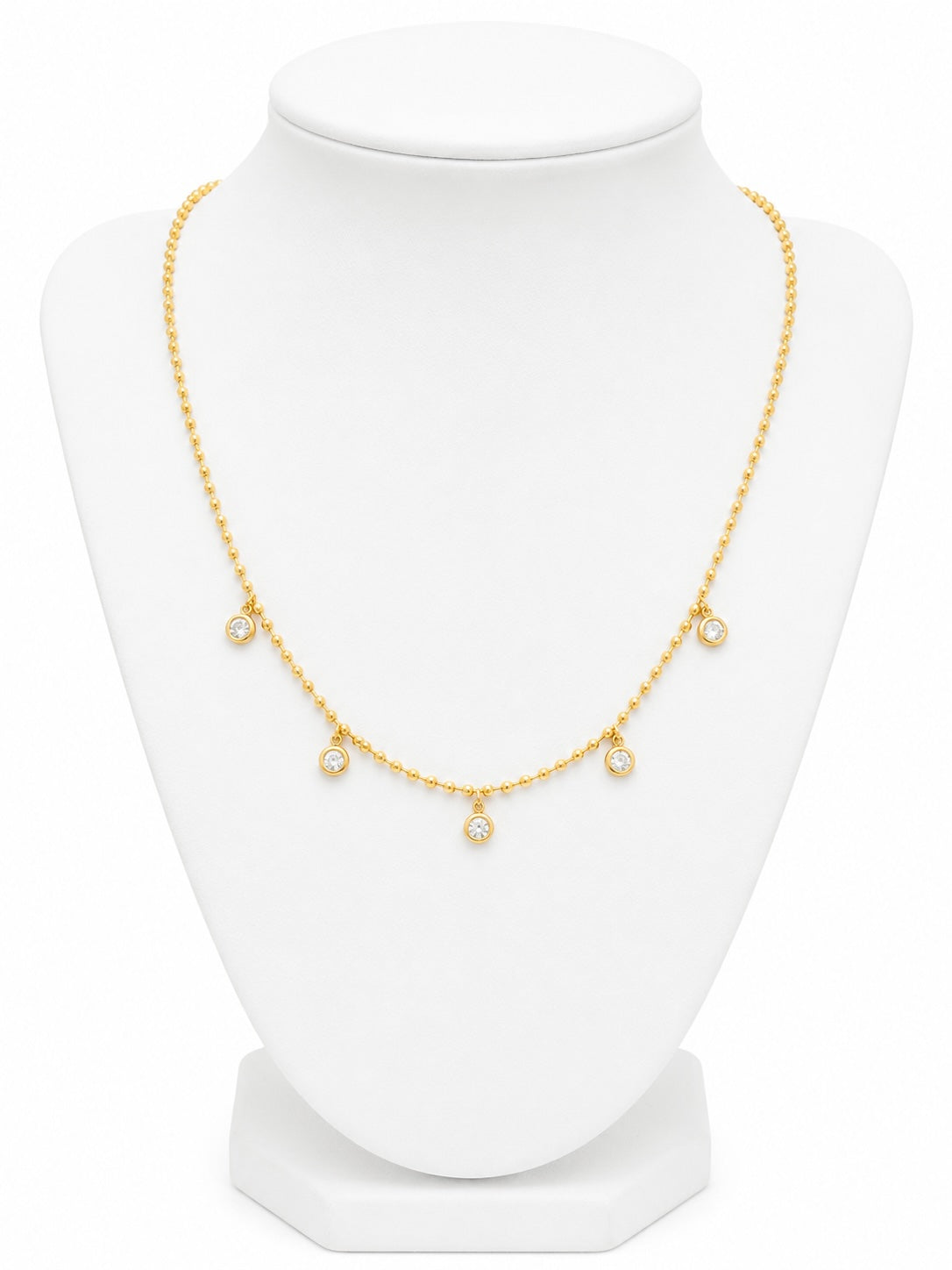 Gold necklace on a white mannequin bust