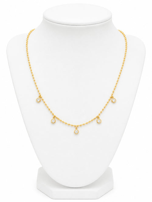 Gold necklace on a white mannequin bust