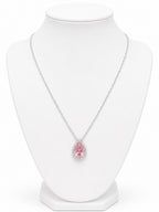 Necklace with a pink teardrop-shaped pendant on a white mannequin bust.