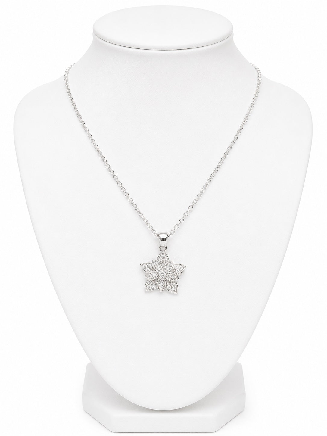 Silver necklace with a star-shaped pendant on a white mannequin bust.