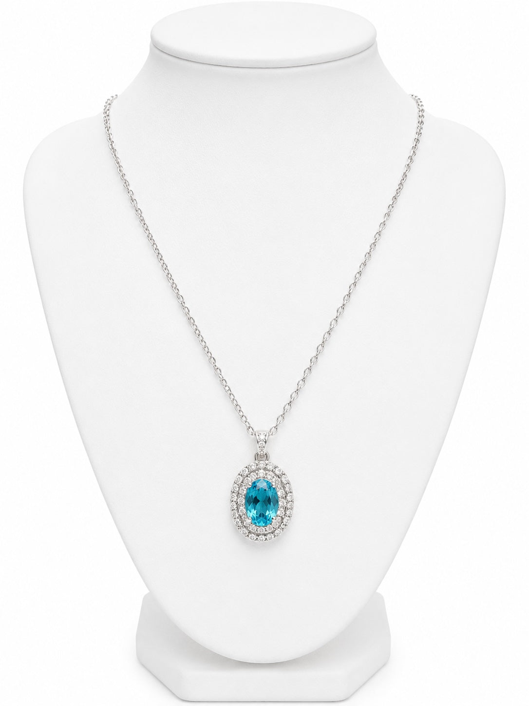 Necklace with a blue gemstone pendant on a white mannequin bust