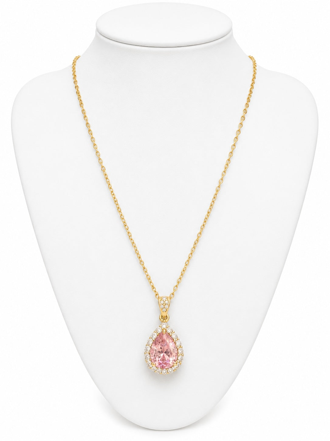 Gold necklace with a pink teardrop pendant on a white mannequin bust.