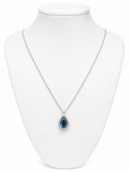 Necklace with a blue teardrop pendant on a white mannequin bust.