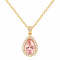 Gold necklace with a pink teardrop-shaped gemstone pendant on a white background