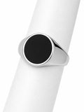 Silver ring with a black stone on a white background