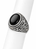 Silver ring with black stone on a white background