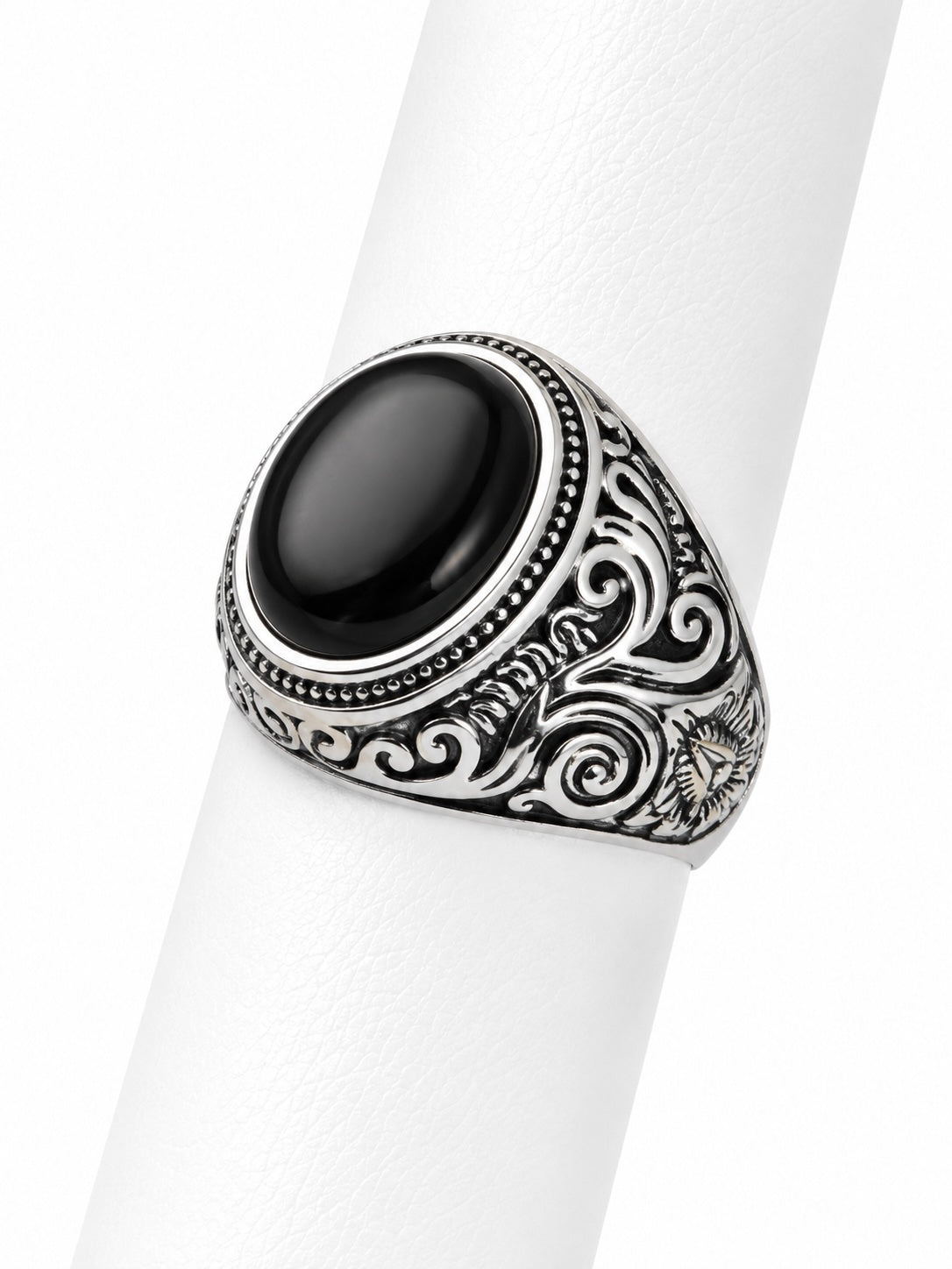 Silver ring with black stone on a white background