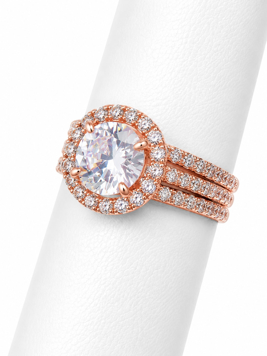 Rose gold ring with a large diamond and smaller diamonds on a white background