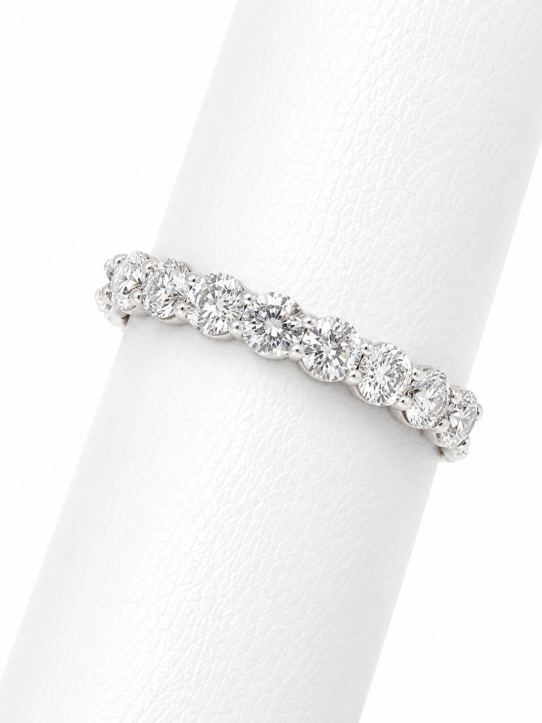 Silver ring with diamonds on a white background