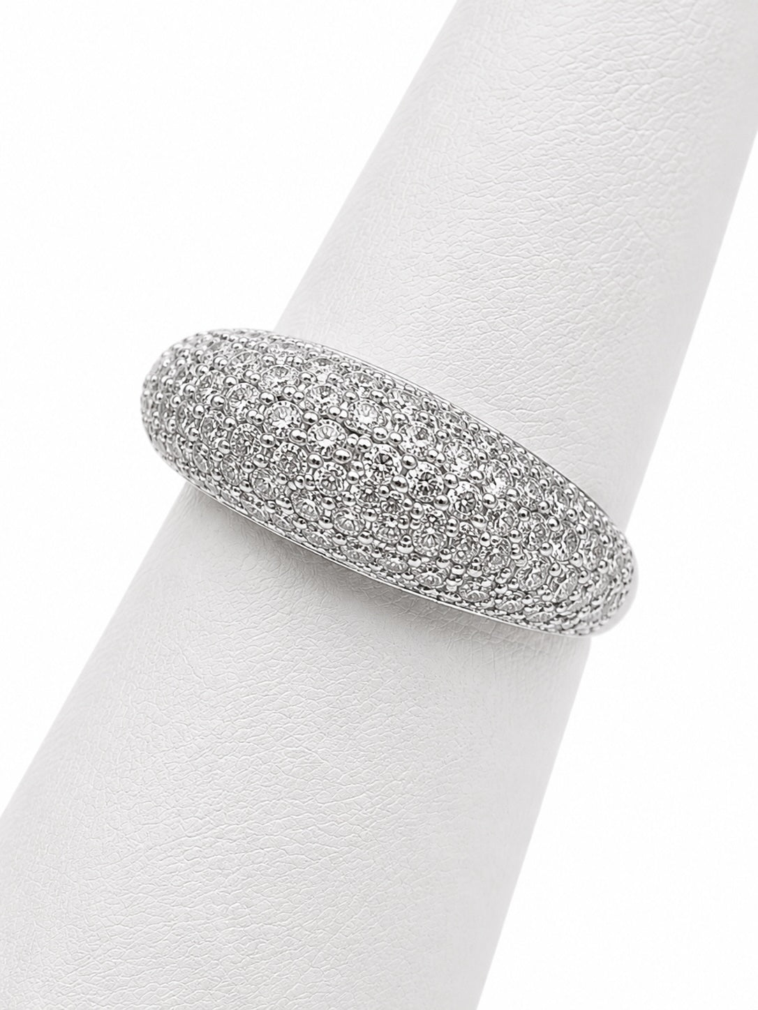 Silver ring with embedded stones on a white napkin