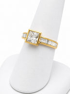 Gold ring with a diamond on a white background