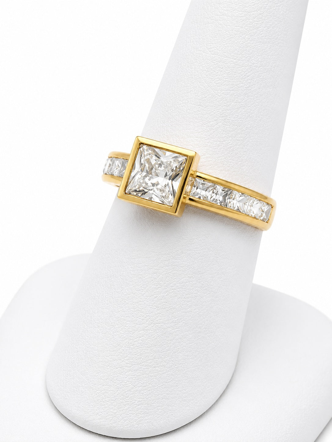 Gold ring with a diamond on a white background