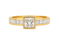 Gold ring with a central diamond and smaller diamonds on a white background