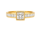Gold ring with a central diamond and smaller diamonds on a white background