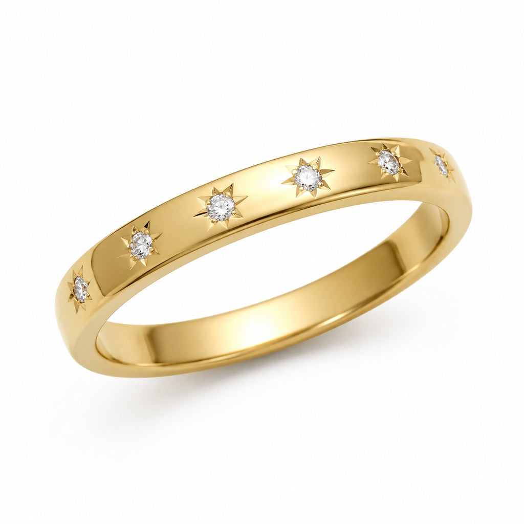 Gold ring with diamond accents on a white background