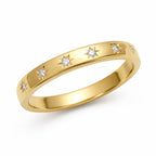 Gold ring with diamond accents on a white background