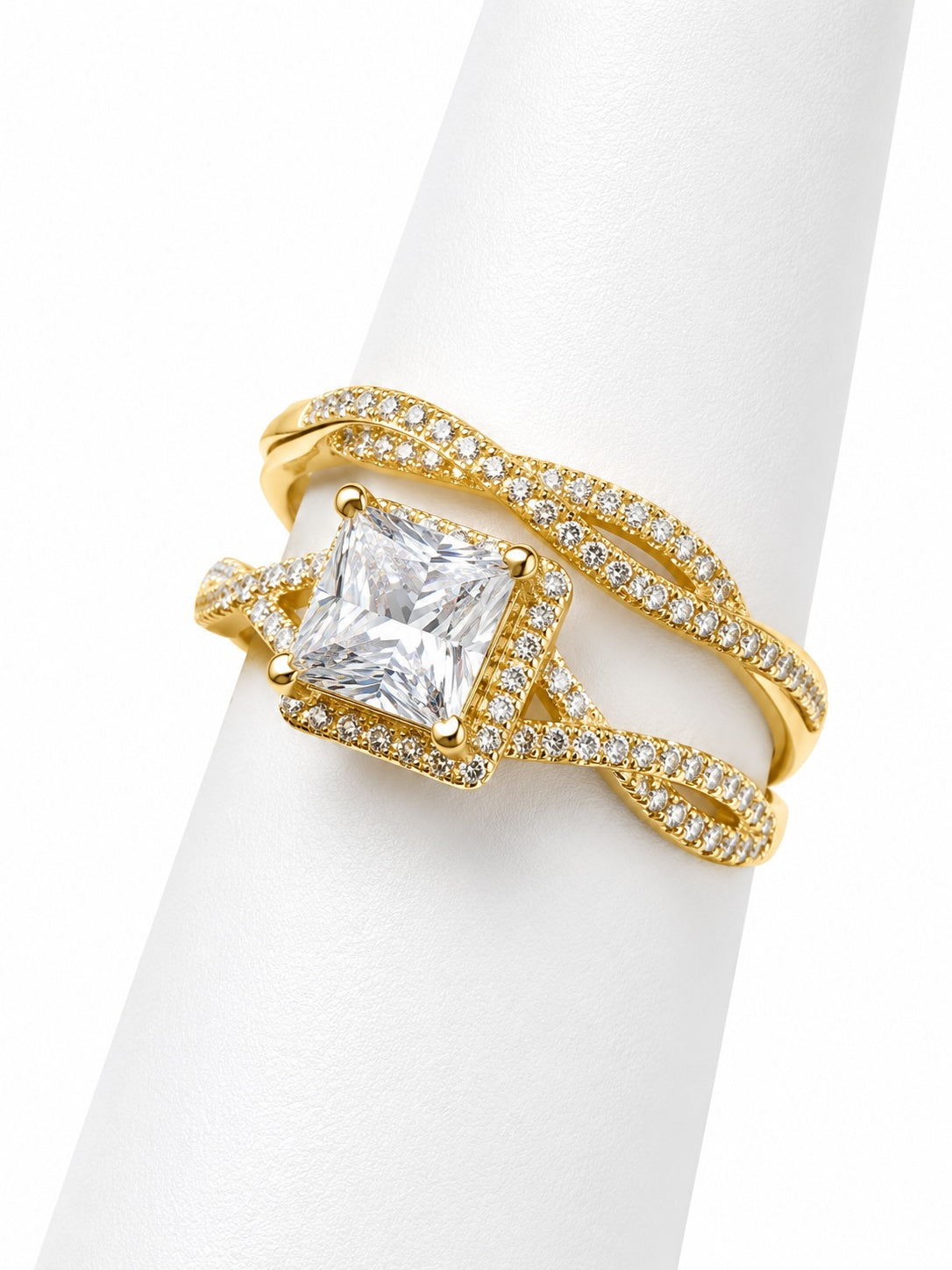 Gold ring with a large diamond on a white background