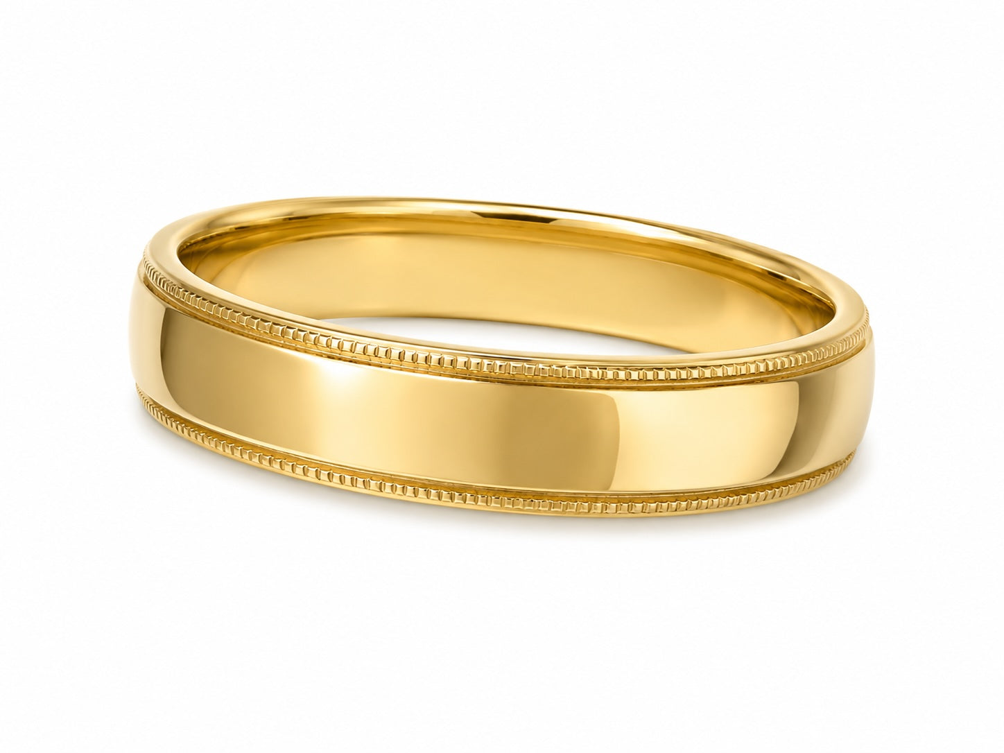 Gold ring with milgrain detailing on a white background