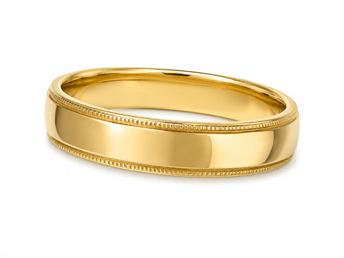 Gold ring with milgrain detailing on a white background