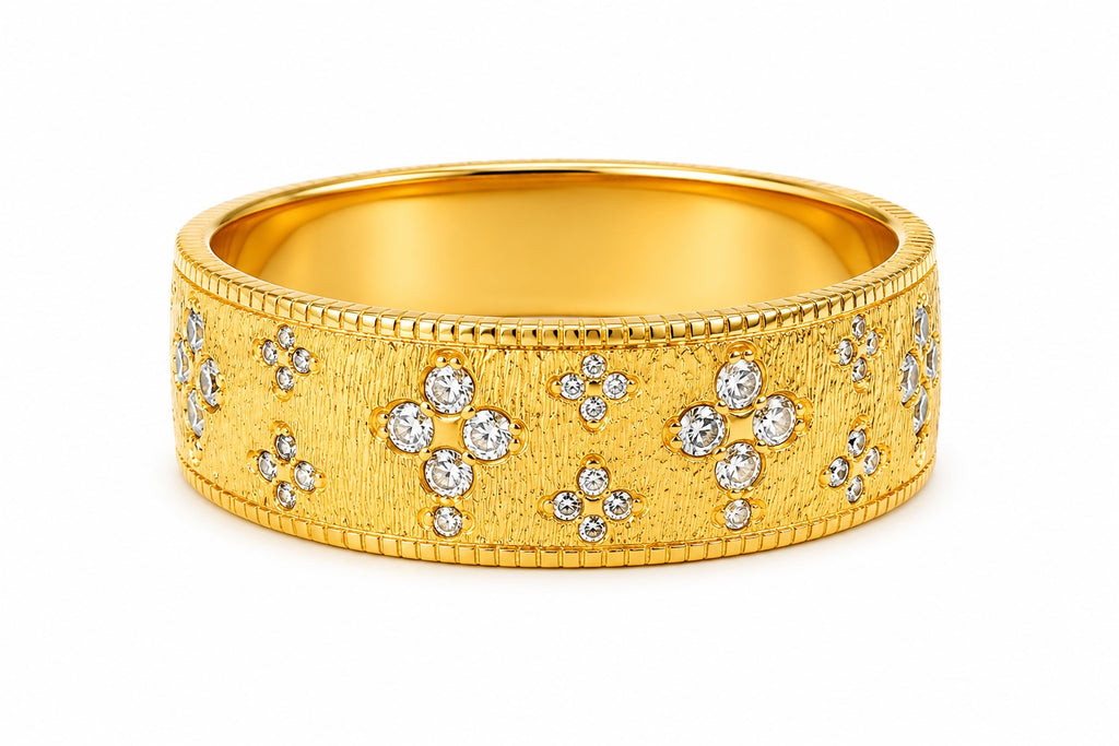 Gold ring with diamond accents on a white background