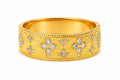 Gold ring with diamond accents on a white background
