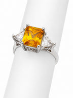 Ring with a yellow gemstone on a white background