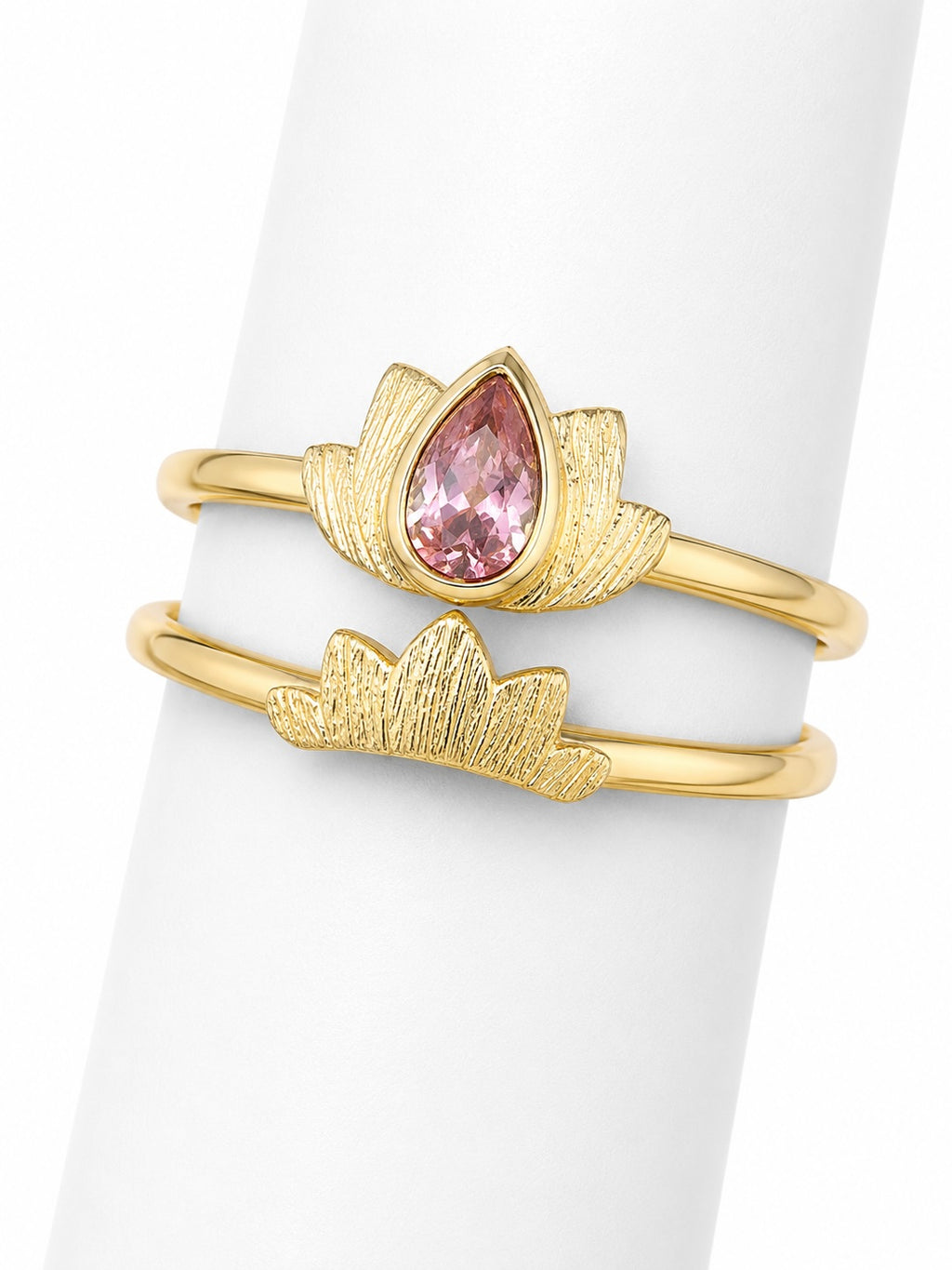 Gold ring with a pink gemstone on a white background
