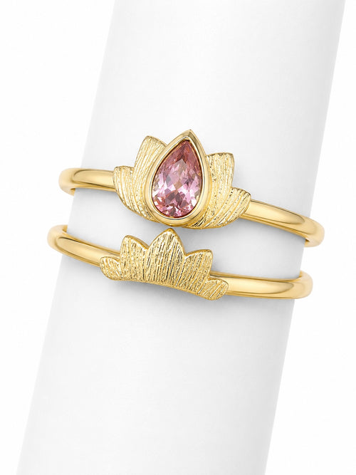 Gold ring with a pink gemstone on a white background