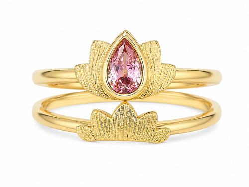 Gold ring with a pink gemstone on a white background