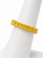 Yellow gemstone ring on a white stand