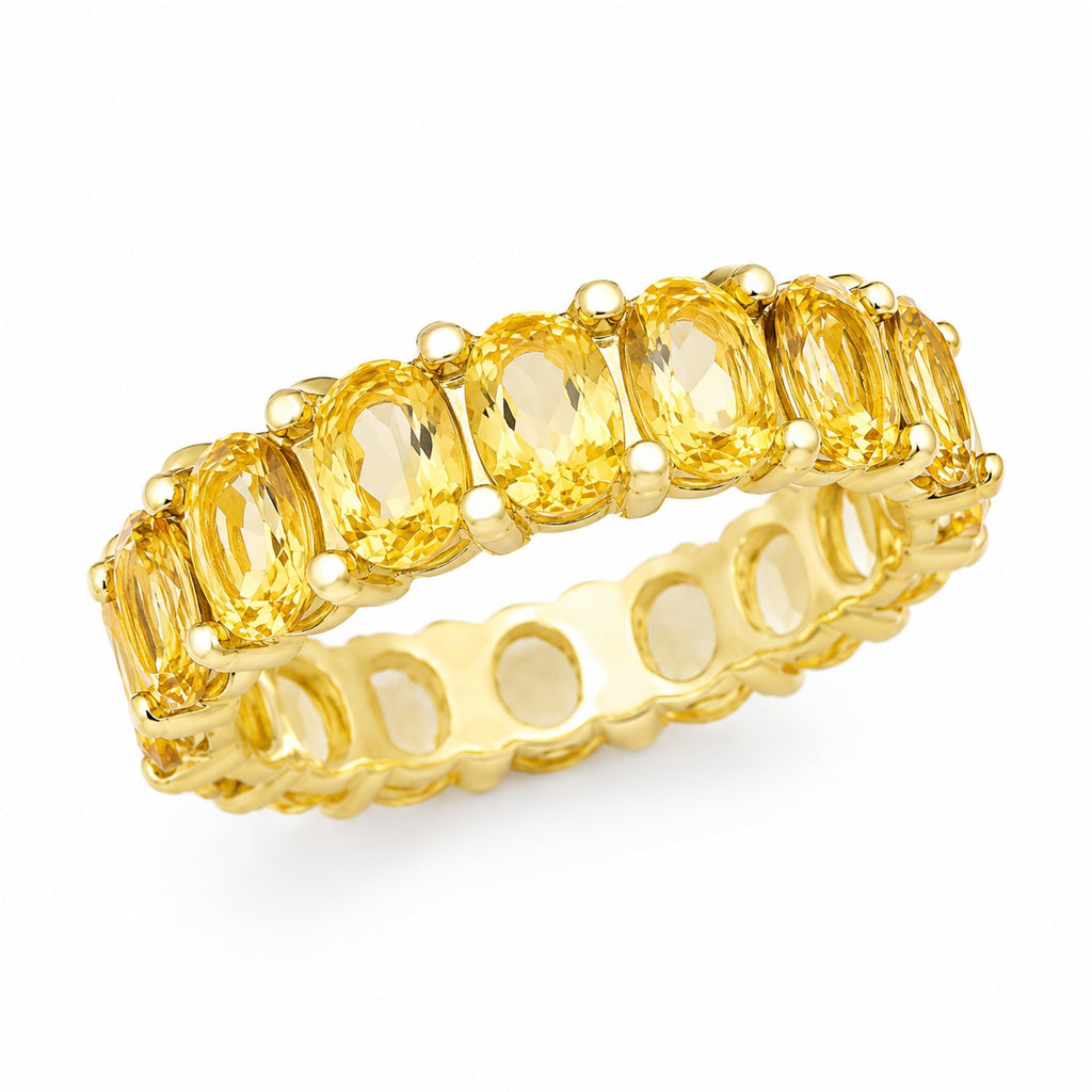 Gold ring with yellow gemstones on a white background