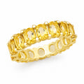 Gold ring with yellow gemstones on a white background