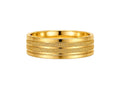 Gold ring with textured band on a white background