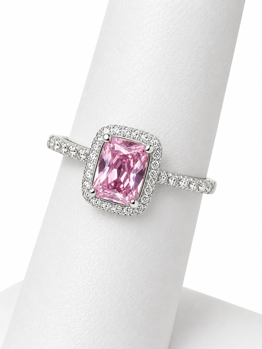 Pink gemstone ring with silver setting on a mannequin hand