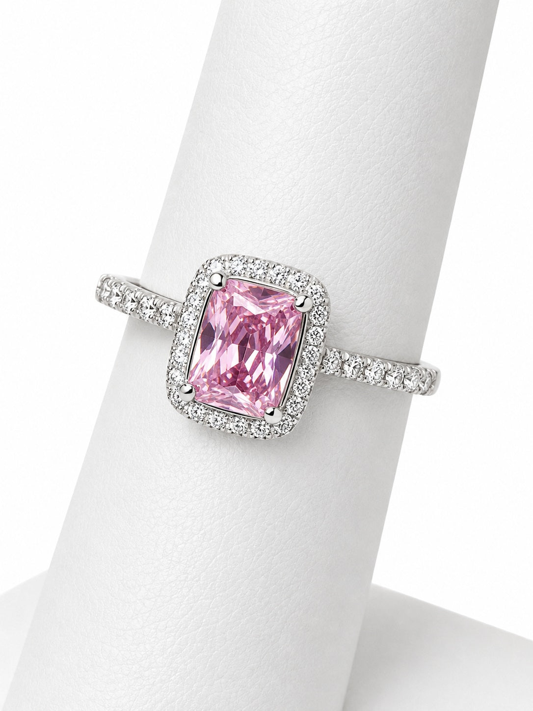 Pink gemstone ring with silver setting on a mannequin hand