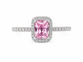 Pink gemstone ring with diamond accents on a white background