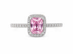 Pink gemstone ring with diamond accents on a white background