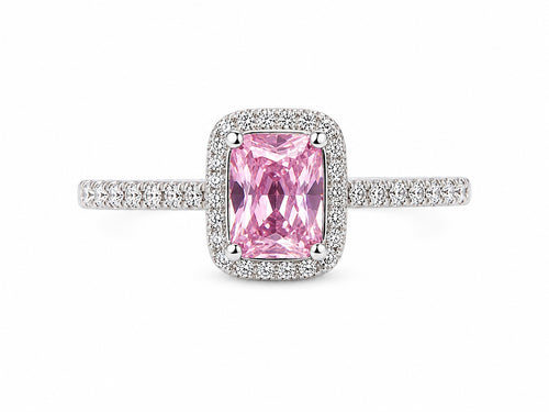Pink gemstone ring with diamond accents on a white background